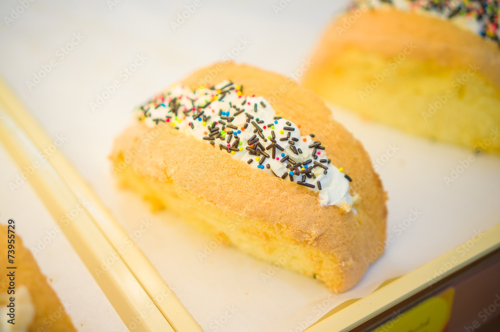 Bun bakery with filled cream, covered with chocolate and rainbow Bun bakery with filled cream, covered with chocolate and rainbow