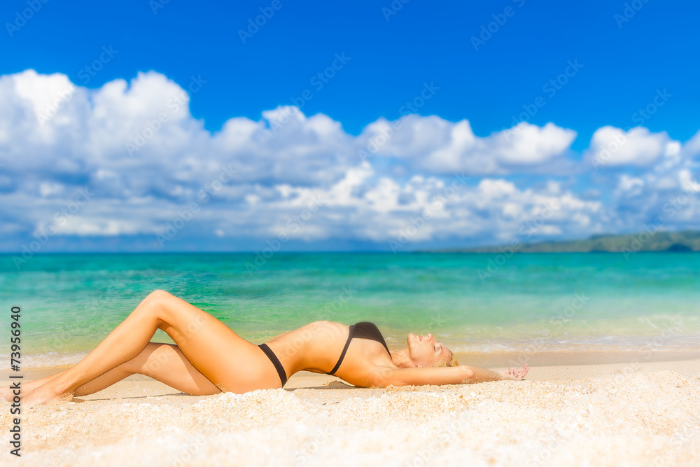 young beautiful woman relaxing on tropical sand beach, sky and s