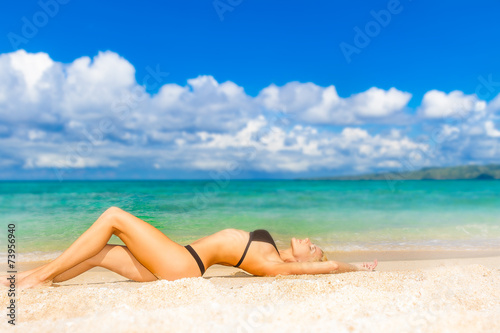 young beautiful woman relaxing on tropical sand beach, sky and s