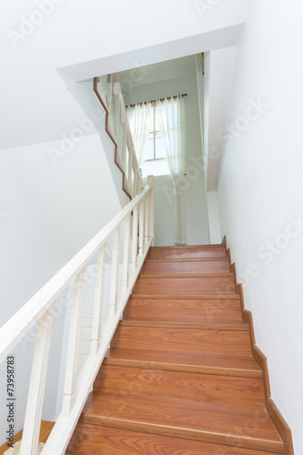 wooden staircase made from laminate wood in white modern house