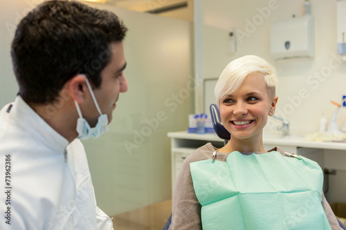 interaction between european dentist and blonde patient