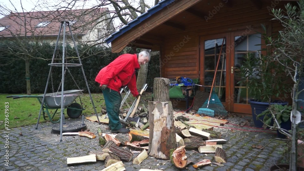 Mann zersägt Holz für Brennholz