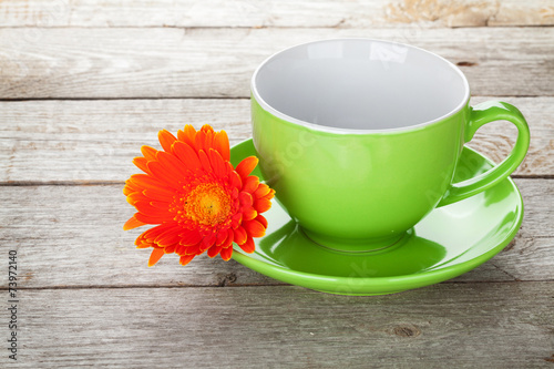 Coffee cup and gerbera flower