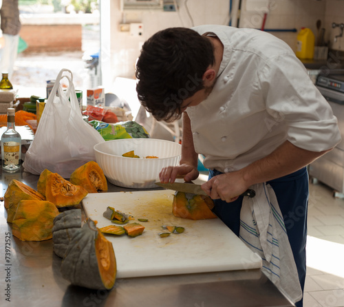 Chef cutting pumpkin