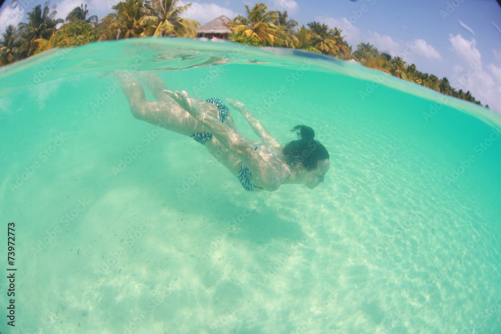 woman swimming in the ocean, diving