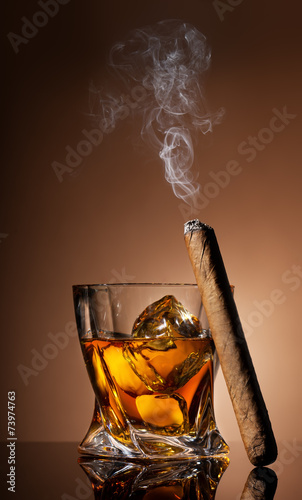 Glass of whiskey and cigar