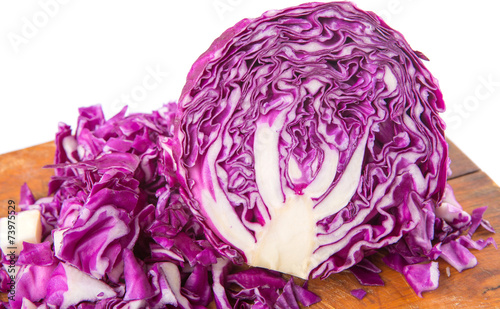 Chopped red cabbage on cutting board over white background