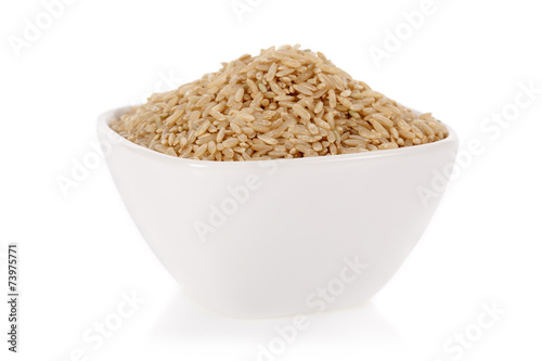 Brown rice in a bowl isolated on a white background