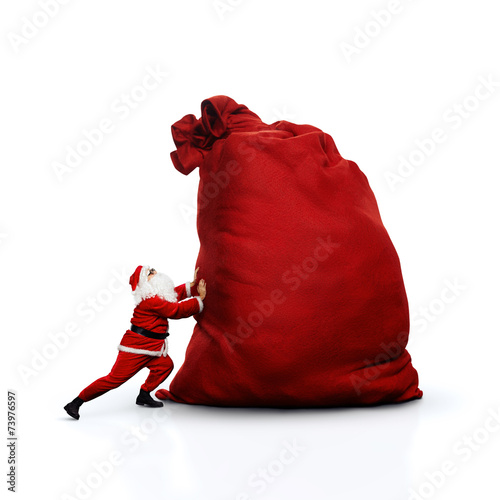 Santa pushing huge sack. Isolated on white.