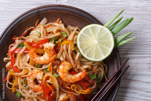 Asian rice noodles with shrimp and vegetables top view