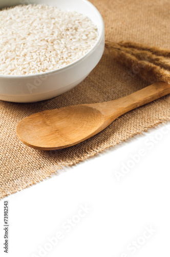 rice cereal and wooden spoon on burlap background. isolate