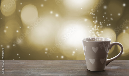 Cup of hot drink on bright background