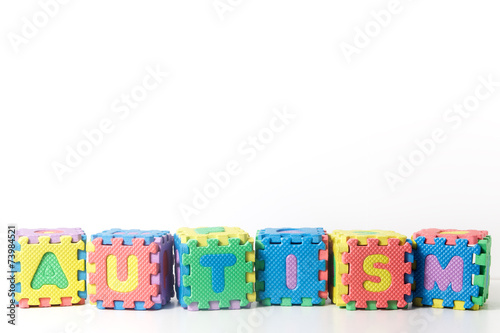 Stacked blocks spelling autism on white background