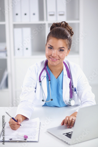 Doctor and patient sitting on the desk at office