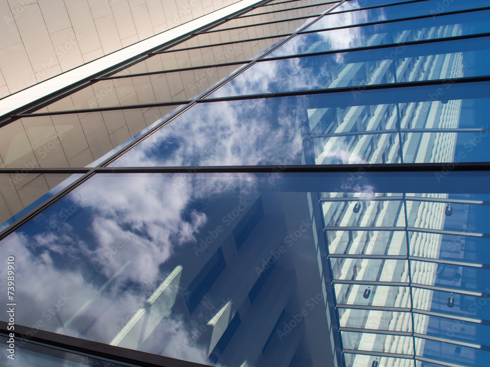 Reflection in the glass facade of a skyscraper in Frankfurt, Ger Reflection in the glass facade of a skyscraper in Frankfurt, Ger