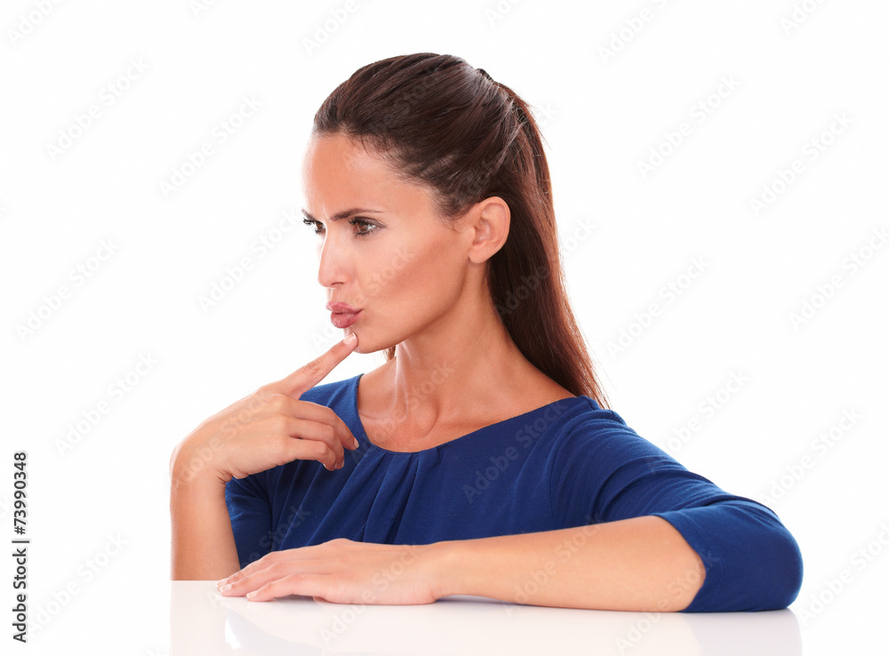 Pretty woman in blue blouse looking to her right Pretty woman in blue blouse looking to her right
