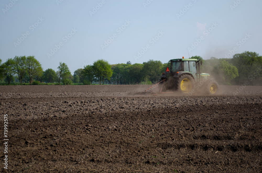 Tractor in plowed field