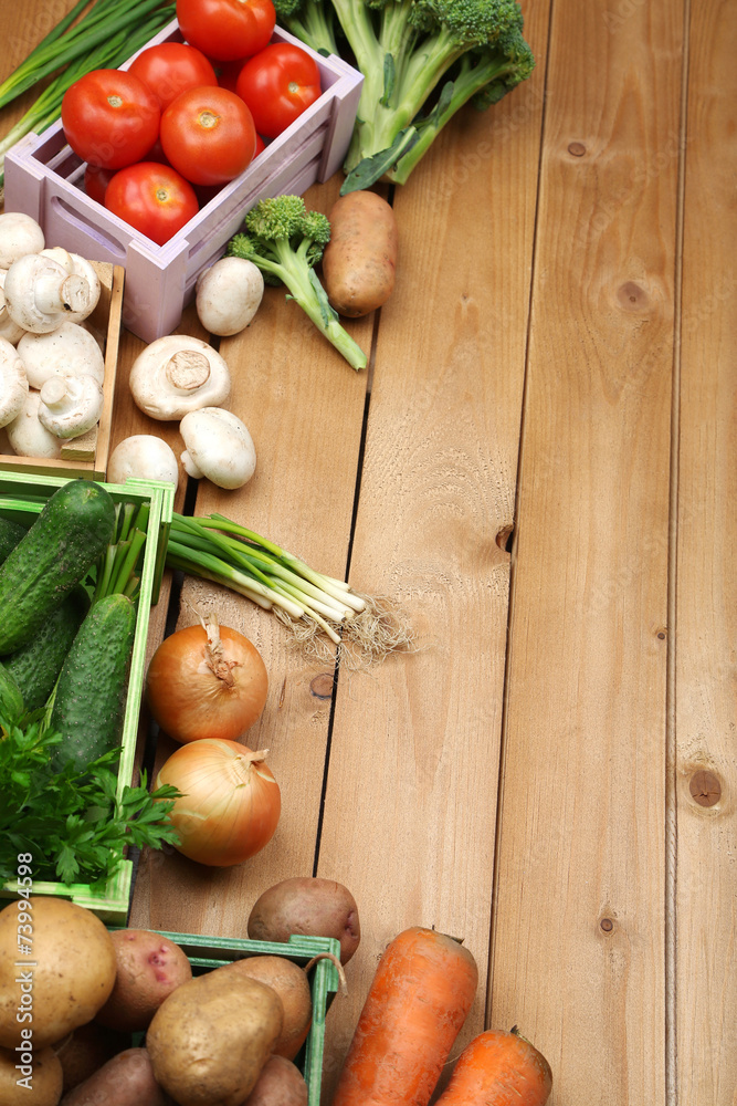 Different vegetables in boxes on wooden background top view Different vegetables in boxes on wooden background top view