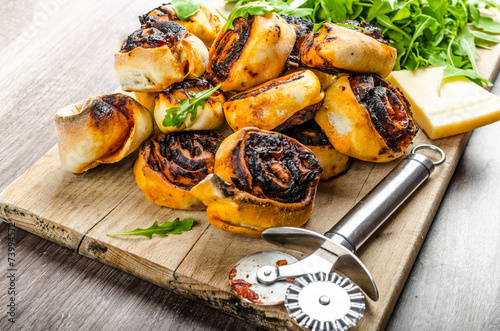 Pizza snails, minipizza with salad and parmagio photo