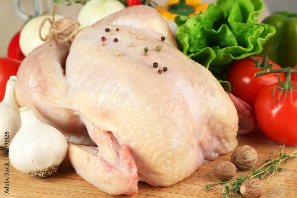 Raw chicken on wooden table