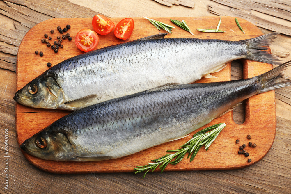 Fresh raw fish and food ingredients on table Fresh raw fish and food ingredients on table