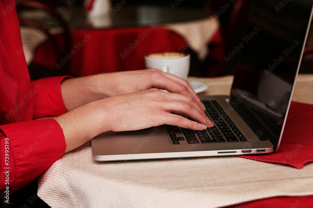 Woman with laptop in cafe shop Woman with laptop in cafe shop