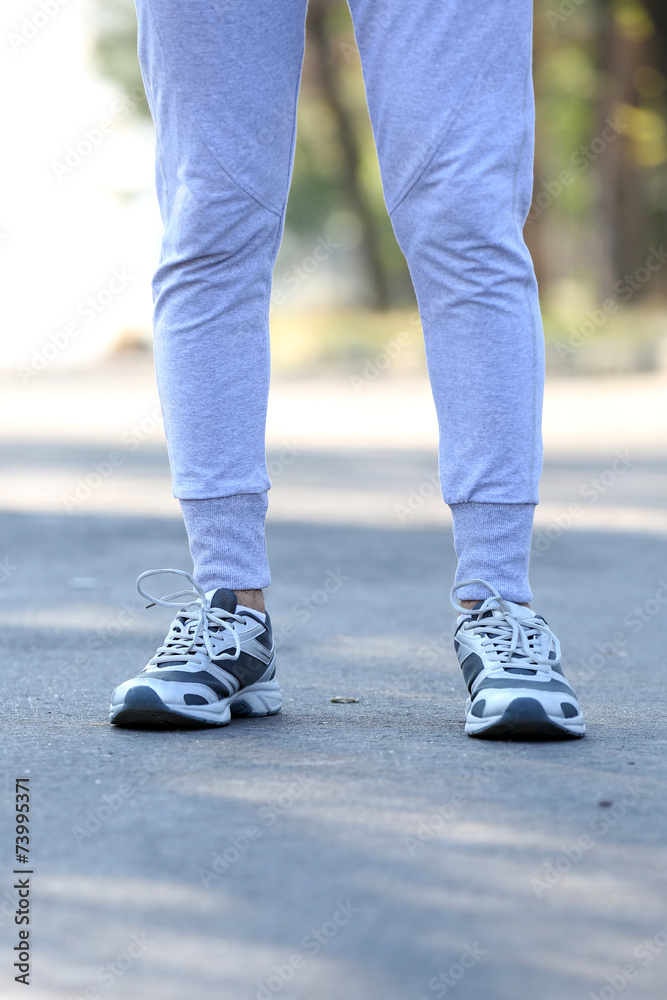 Runner feet on road, outdoors Runner feet on road, outdoors