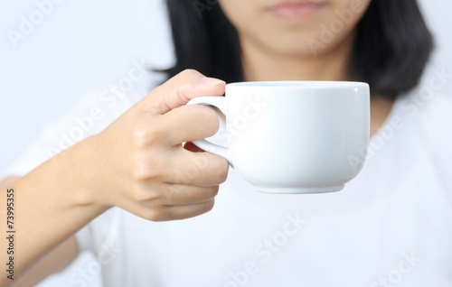 Woman holding a coffee cup.
