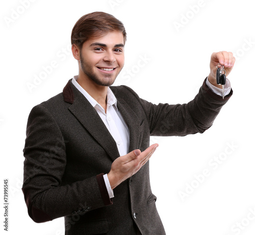Businessman holding car key...