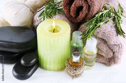 Branches of rosemary and sea salt  towels  candle and bottle