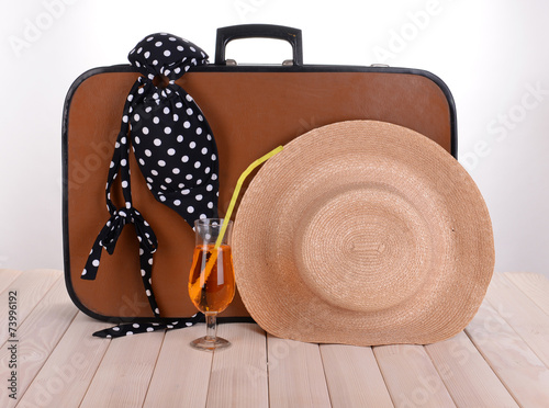 Vintage valise with summer items on wooden board Fototapeta
