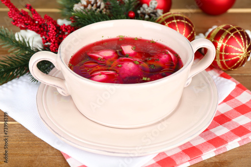 Traditional polish clear red borscht with dumplings and