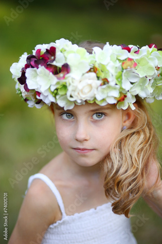happy little girl in a floral wreath