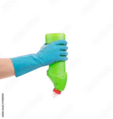 Hand holding green bottle.