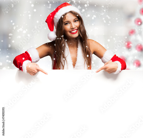 Girl dressed for Christmas showing a blank board
