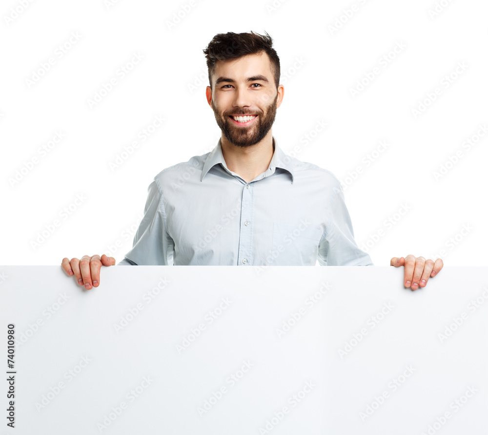 A young bearded man showing blank signboard, isolated over white A young bearded man showing blank signboard, isolated over white