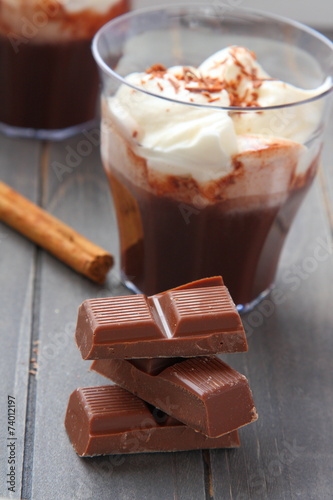 Chocolate pieces with chocolate milkshake and cinnamon stick