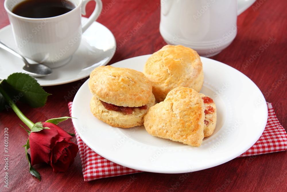 Home made scones with strawberry jam and a cup of tea Home made scones with strawberry jam and a cup of tea