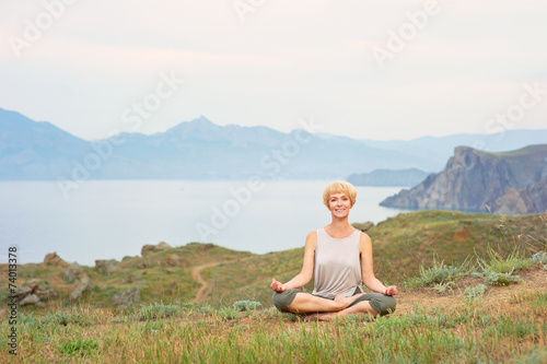 Senior woman doing yoga exercises