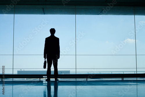 silhouette of businessman in office interior