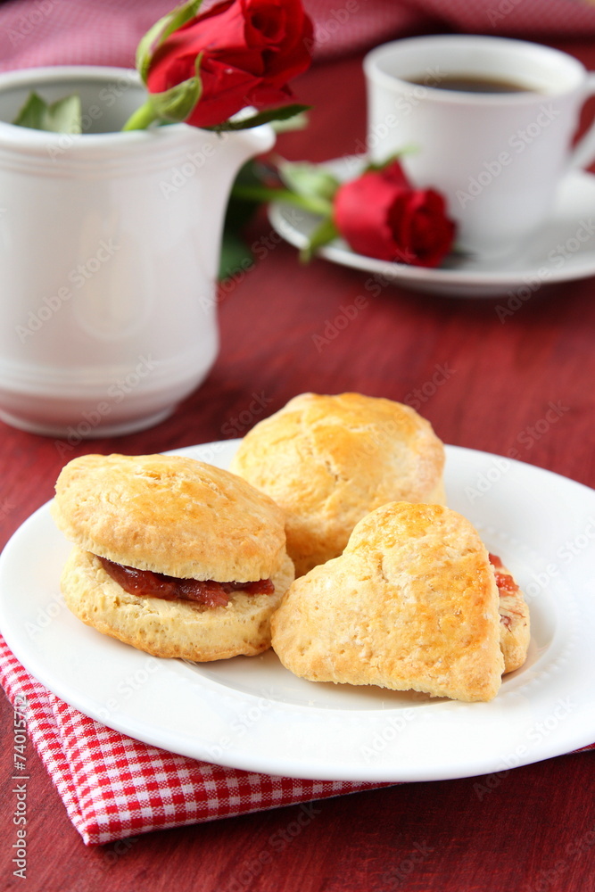 Home made scones with strawberry jam and a cup of tea Home made scones with strawberry jam and a cup of tea