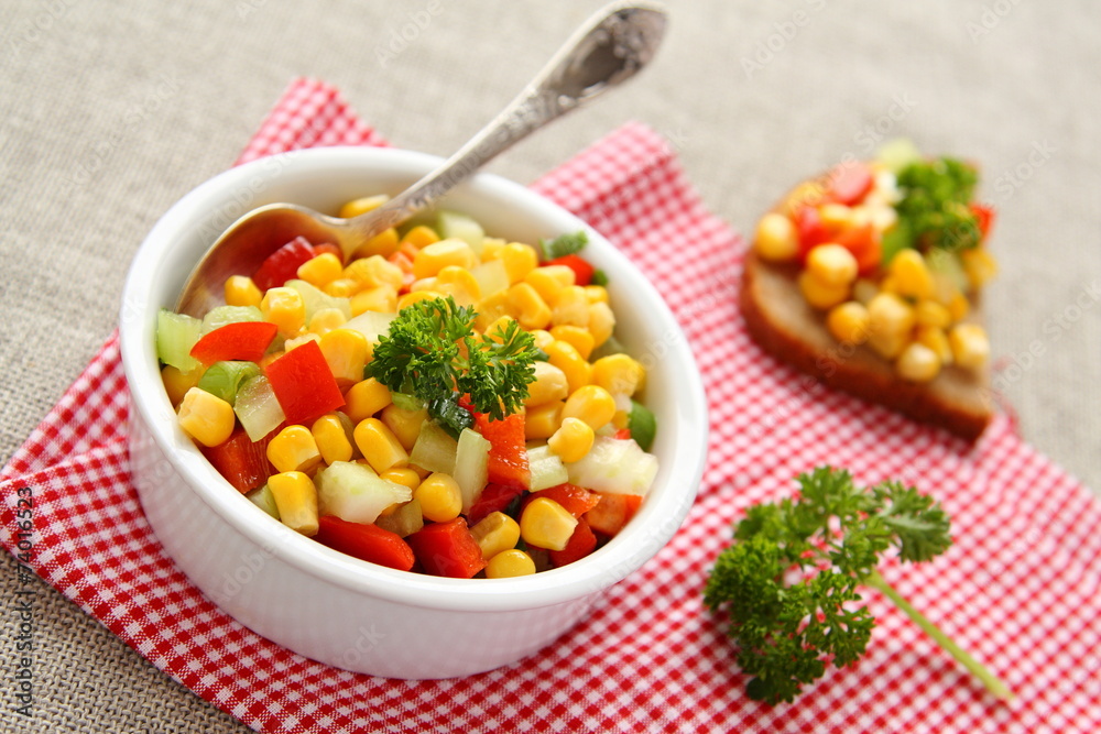Homemade corn salsa in white bowl with spoon Homemade corn salsa in white bowl with spoon