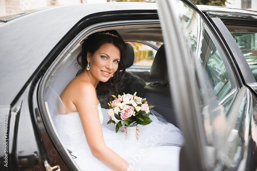 Young bride in a wedding car