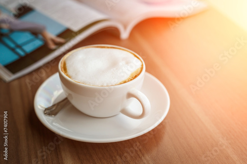 Coffee cup and book on the table
