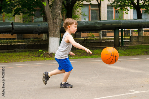 Little boy playing basketball