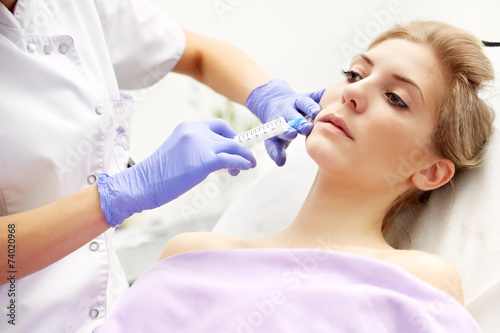Beautiful woman gets an injection in her face