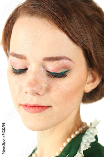 Lovely young woman with make up and green vintage dress