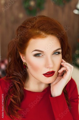 Woman in red dress and red lipstick looking in camera