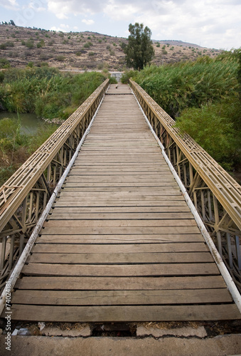 Fototapeta Naklejka Na Ścianę i Meble -  Old bridge across river Jordan