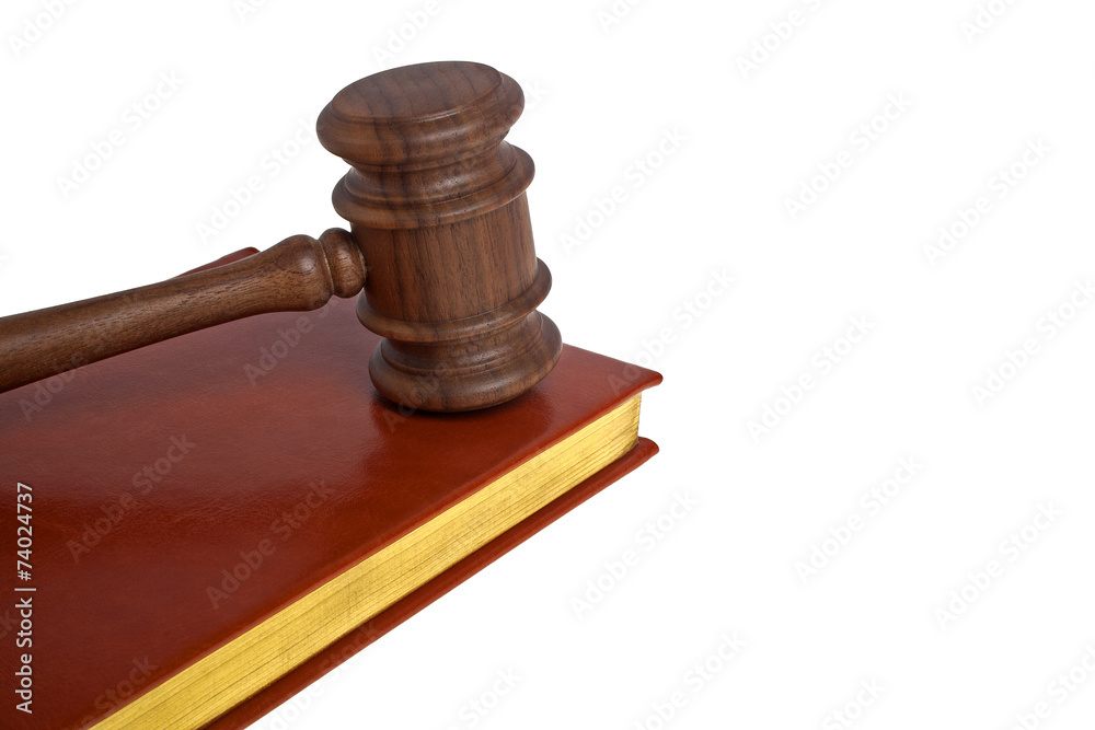 Wooden mallet and book on a white background